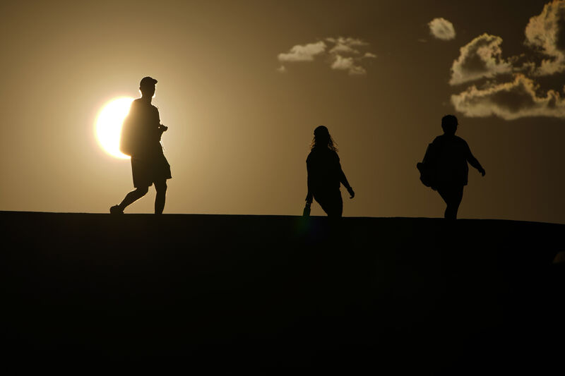 People walk along a trail as the sun sets in Death Valley National Park, California. File picture: AP Photo/John Locher