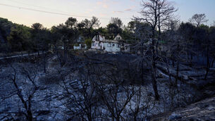 A damaged house is seen in Penteli, a suburb of Athens following the wildfire (Petros Giannakouris/AP/PA) A damaged house is seen in Penteli, a suburb of Athens following the wildfire (Petros Giannakouris/AP/PA)
