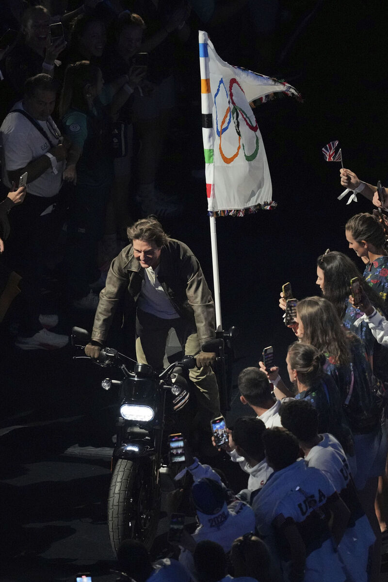 And then, as if that wasn't exhausting enough, he runs across the stage without tripping or falling, before leaping onto a motorcycle without wounding his backside. Picture: AP/Dita Alangkara