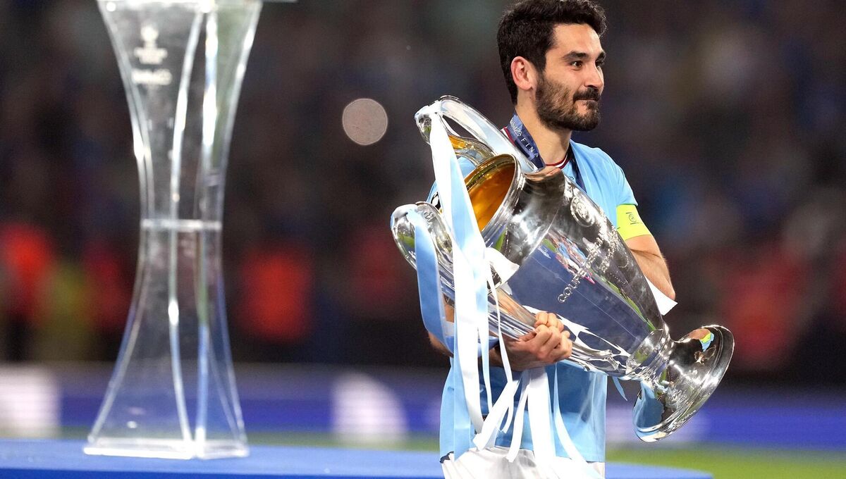 Gundogan holding the Champions League Trophy with Manchester City