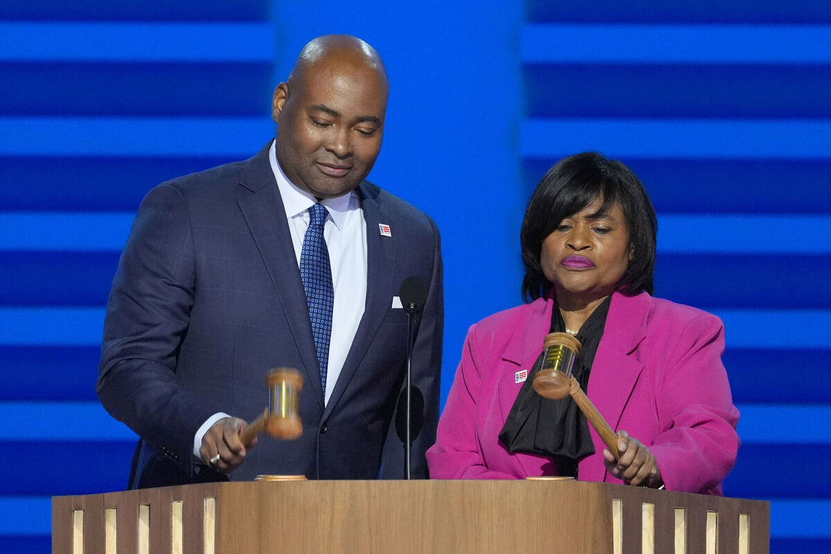 Minyon Moore, right, chair of the 2024 Democratic National Convention Committee, and Jaime Harrison, left, chair of the Democratic National Committee, gavel in to start the first day of the Democratic National Convention on Monday, Aug. 19, 2024, in Chicago. (AP Photo/J. Scott Applewhite)