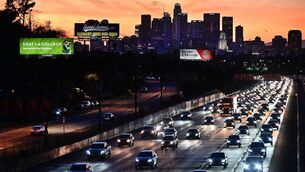 <p>Cars make their way heading east out of Los Angeles during the evening rush hour </p>