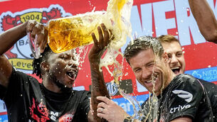 <p>Leverkusen's head coach Xabi Alonso , centre, is sprayed with beer after Bayer Leverkusen won the German Bundesliga title. (AP Photo/Martin Meissner)</p>