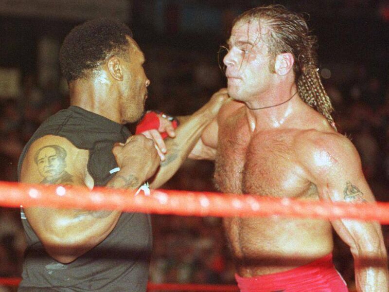 Mike Tyson in the ring with Shawn Michaels. Picture: John Mottern /AFP Mike Tyson in the ring with Shawn Michaels. Picture: John Mottern /AFP