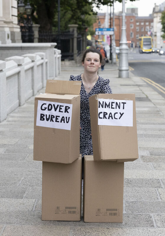 Cara knocks over a mock up demonstration of Government Bureaucracy in Boxes. Picture: Sam Boal/Collins 