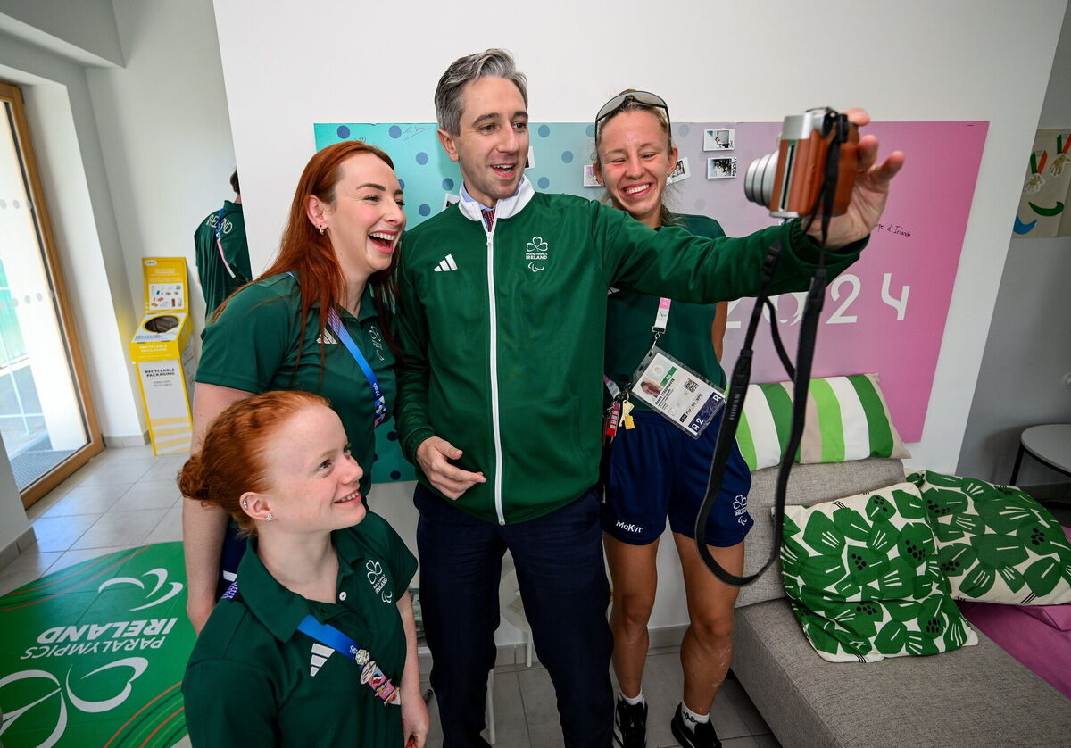 An Taoiseach Simon Harris TD takes a selfie with Ireland athletes, from left, Dearbhaile Brady, Ellen Keane and Greta Streimikyte.