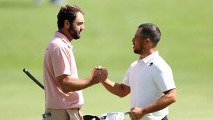 <p>Scottie Scheffler and Xander Schauffele shake hands on the 18th green during the second round of the BMW Championship</p>