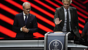 <p>Former Swedish soccer player Glenn Stromberg, right, flanked by UEFA's Giorgio Marchetti, presses a button to proceed with the UEFA Europa League phase draw, in Monaco. Pic: AP Photo/Gregorio Borgia</p>