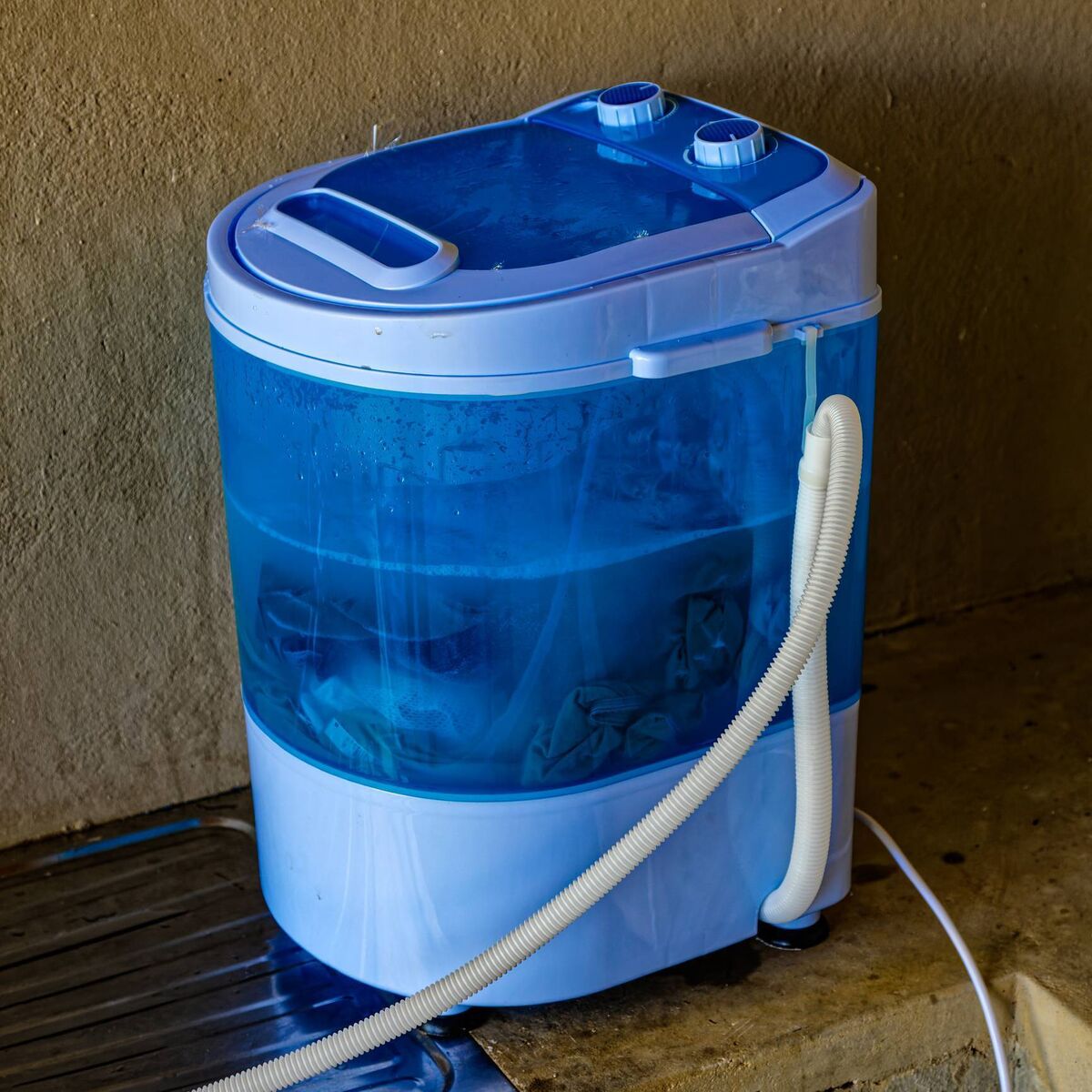 Portable plastic camping washing machine in use. File picture