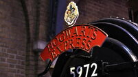 etail of the Hogwarts express locomotive with the red writing and the number of the train departing from platform nine and three