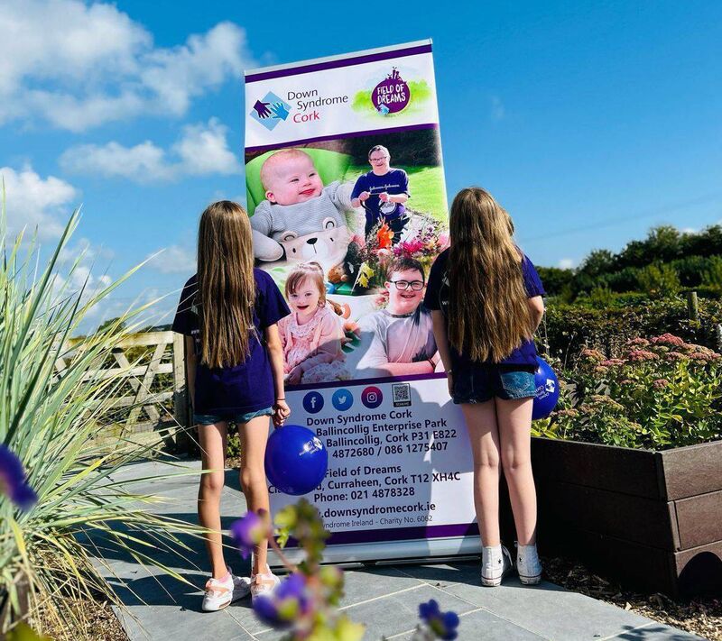 Cara Murphy and Nell Collins with their shiny long hair before they donated it