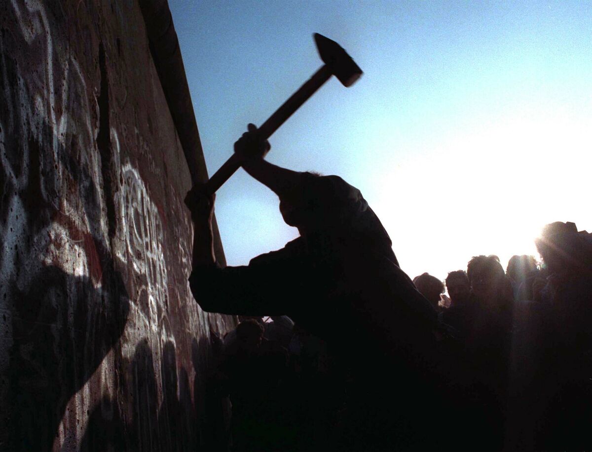 .A man hammers away at the Berlin Wall in 1989 as the border barrier between East Germany and West Germany was torn down after 28 years, symbolically ending the Cold War. 