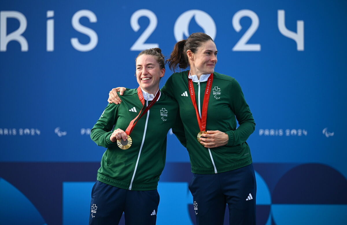 THREE-PEAT: Katie-George Dunlevy, right, and pilot Linda Kelly of Ireland celebrate with their gold medals. Photo by Ramsey Cardy/Sportsfile