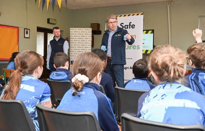 Robert Corroon, with Irish Farmers' Association animal health committee chairman TJ Maher discussing to students how to be safe around and also the dangers of working around livestock on farms at the Safe Farm Futures farm safety workshop in Moycarkey National School. Picture: Agri Aware