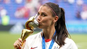 <p>USA's Alex Morgan celebrates with the FIFA Women's World Cup Trophy and adidas Silver Boot award after the final whistle after the FIFA Women's World Cup 2019 Final at the Stade de Lyon, Lyon, France.</p>