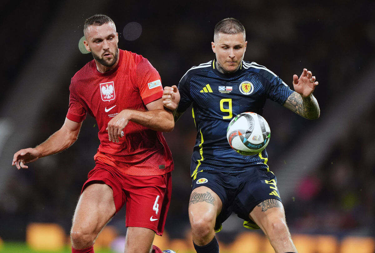 Scotland's Lyndon Dykes and Poland's Sebastian Walukiewicz during the UEFA Nations League, Group A1 match at Hampden Park. Pic Andrew Milligan/PA Wire. 