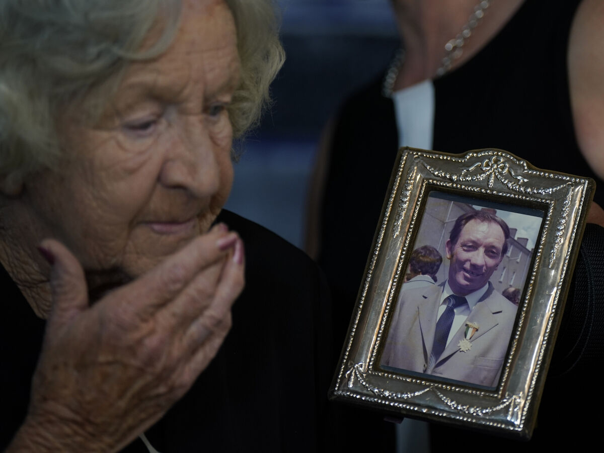 Jean Lahiffe, wife of the late Detective Garda Morgan Lahiffe, holds his picture ahead of a Bronze Scott Medal being awarded posthumously to him. Picture: Niall Carson/PA