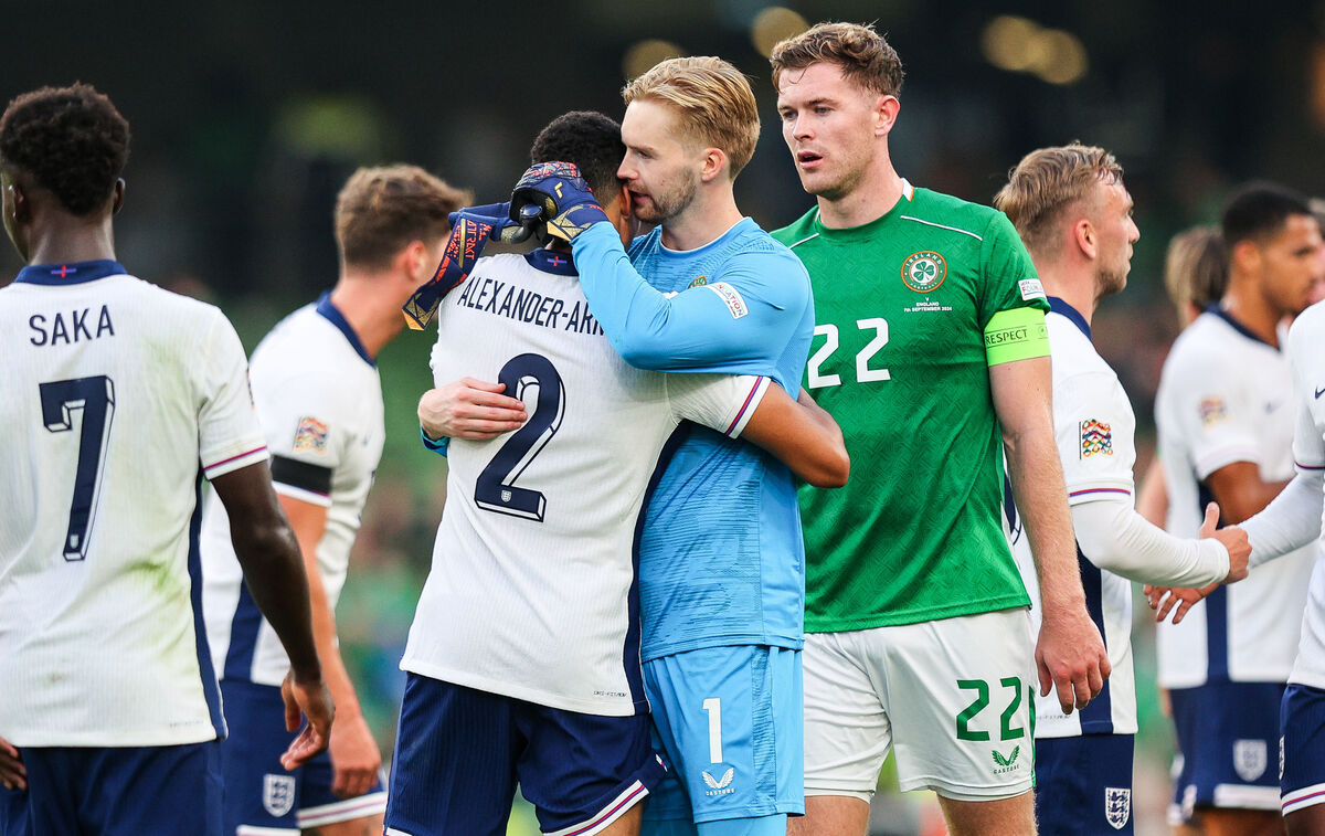 Ireland's Caoimhín Kelleher embraces Liverpool teammate Trent Alexander-Arnold of England.