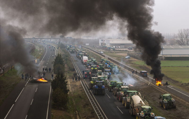Farmers blocking a highway during a protest near Mollerussa, northeast Spain, in February. Picture: AP /Emilio Morenatti Farmers blocking a highway during a protest near Mollerussa, northeast Spain, in February. Picture: AP /Emilio Morenatti