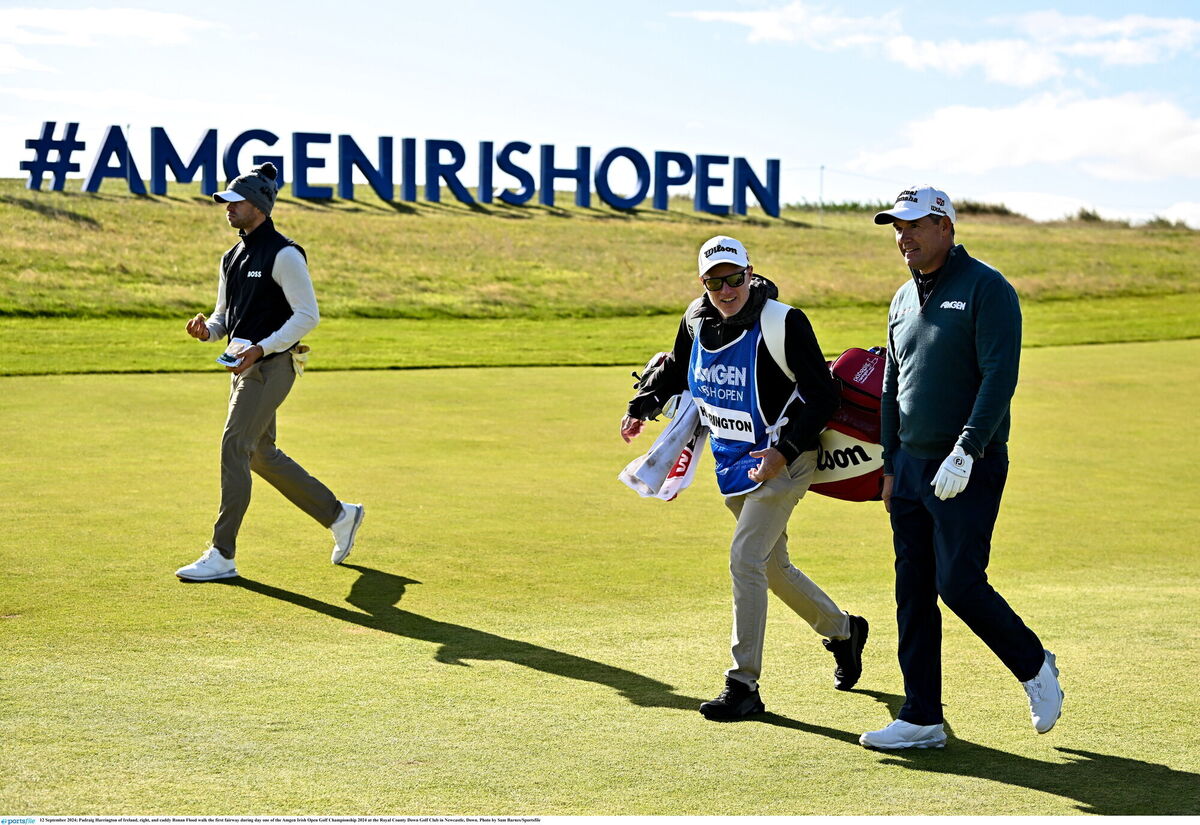 Padraig Harrington and caddy Ronan Flood walk the first fairway