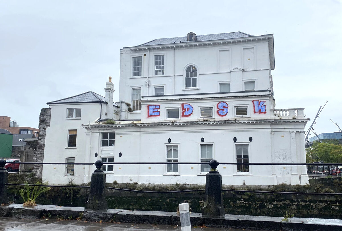 Taggers spray-painted four large letters, EDSK, onto the southern facade of the building, which overlooks the southern channel of the River Lee. Taggers spray-painted four large letters, EDSK, onto the southern facade of the building, which overlooks the southern channel of the River Lee.