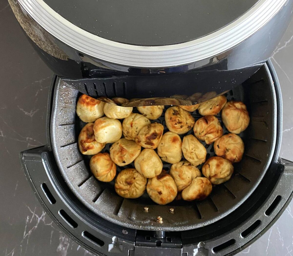 When cooking foods like these delicious Asian dumplings, avoid charring or burning food to reduce the release of neurotoxic acrylamides, put on your kitchen extractor, and don’t breathe in the fumes form the pan as its withdrawn. File picture