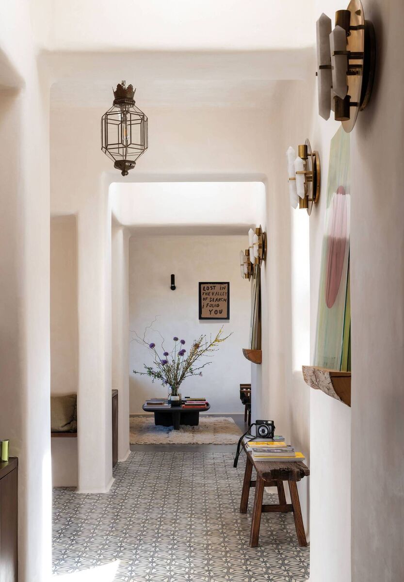 The Ibiza home of Sophie Daunais has characterful tilework by Moroccan artisans and wooden detailing including plinths for art display.