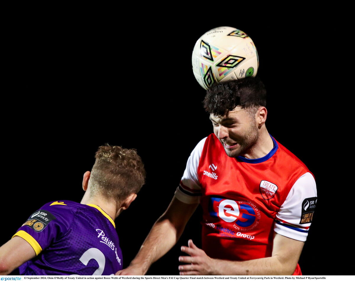 Oisin O'Reilly rises to head the ball. Oisin O'Reilly rises to head the ball.Â