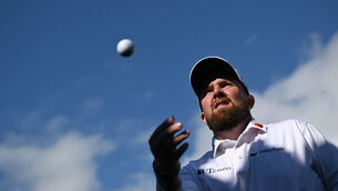 <p>MISSING HOME: Shane Lowry throws a ball to the gallery as he leaves the 18th green after finishing his round during day four of the Amgen Irish Open Golf Championship. Picture:Brendan Moran/Sportsfile</p>