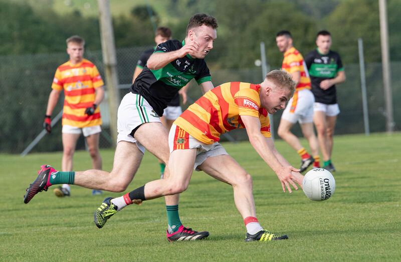 Newcestown's Richard O'Sullivan reaches out for the ball ahead of Nemo Rangers' Barry Cripps. Picture: Howard Crowdy Newcestown's Richard O'Sullivan reaches out for the ball ahead of Nemo Rangers' Barry Cripps. Picture: Howard Crowdy