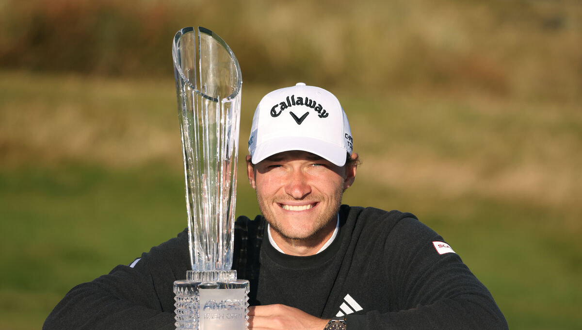 Denmark's Rasmus Hojgaard poses for a photo with the trophy after winning the Amgen Irish Open.