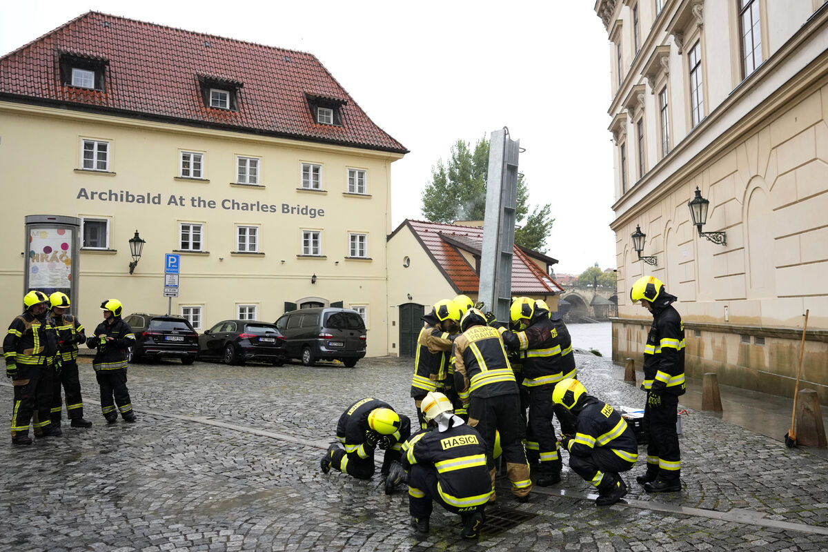 Firefighters adjust parts of the anti-flood barriers in Prague, Czech Republic, on Friday. Picture: AP /Petr David Josek Firefighters adjust parts of the anti-flood barriers in Prague, Czech Republic, on Friday. Picture: AP /Petr David Josek