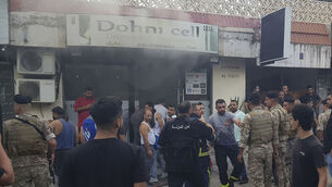 <p>Lebanese soldiers and firefighters gather outside a mobile shop after what is believed to be the result of a walkie-talkie exploding inside it, in the southern port city of Sidon, Lebanon, on Wednesday, September 18. Picture: Mohammed Zaatari/AP</p>