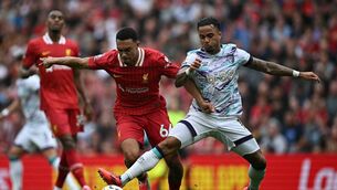<p>Liverpool's Trent Alexander-Arnold challenges Bournemouth striker Justin Kluivert during the Premier League match at Anfield. Photo by Paul Ellis/ AFP </p>