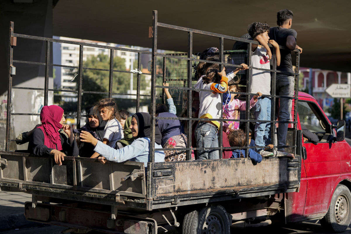 Lebanese citizens who fled from the southern villages amid ongoing Israeli airstrikes on Monday sit in a pick-up in Beirut today. Photo: AP/Hassan Ammar
