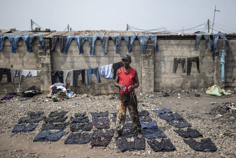 A vendor displays custom-painted second-hand jeans for resale at the Kantamanto textile market in Accra, Ghana. Picture: Andrew Caballero-Reynolds/Bloomberg via Getty Images