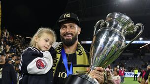 <p>FAMILY AFFAIR: Oliver Giroud of Los Angeles FC hoisting the trophy with daughter Jade after the win over Sporting Kansas City in the finals of the 2024 Lamar Hunt U. S. Open Cup at BMO Stadium on September 25, 2024 in Los Angeles, California. (Photo by Michael Owens/USSF/Getty Images for USSF)</p>