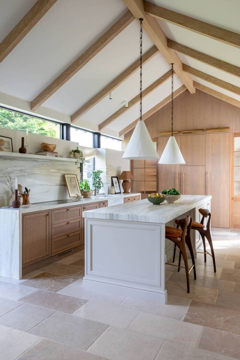 The ceiling height and addition of beams enhance the sense of space in the kitchen area. The ceiling height and addition of beams enhance the sense of space in the kitchen area.