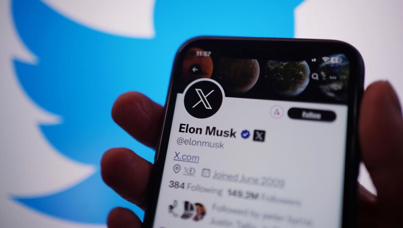 A phone displays the X account for Elon Musk. 