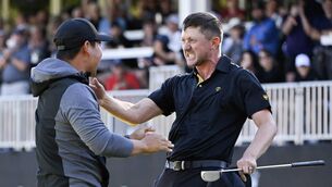 <p>MACK ATTACK: Tom Kim celebrates with Mackenzie Hughes of the International Team after their teams win on the 18th green during Friday's Foursomes matches on day two of the 2024 Presidents Cup at The Royal Montreal Golf Club on September 27, 2024 in Montreal, Quebec. Pic: Ben Jared/PGA TOUR via Getty Images</p>