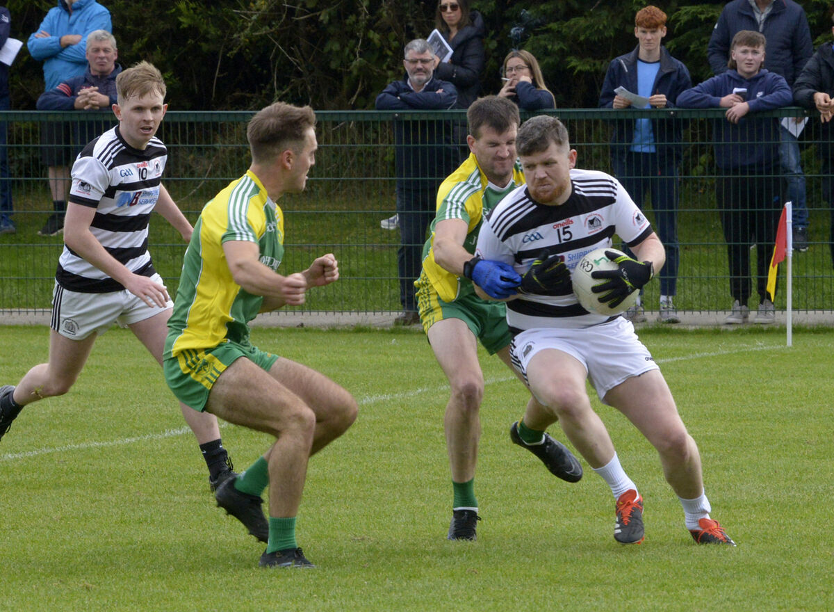 Jamie Corkery for St Nick's breaking through the tackle of Tadhg Feen. Picture Denis Boyle