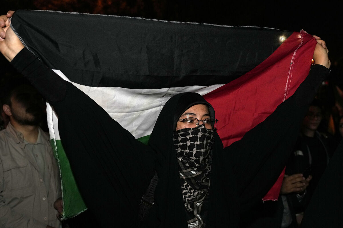 A demonstrator holds a Palestinian flag during an anti-Israeli gathering celebrating Iran's missile strike against Israel in front of the British Embassy in Tehran, Iran, Tuesday, Oct. 1, 2024. (AP Photo/Vahid Salemi)
