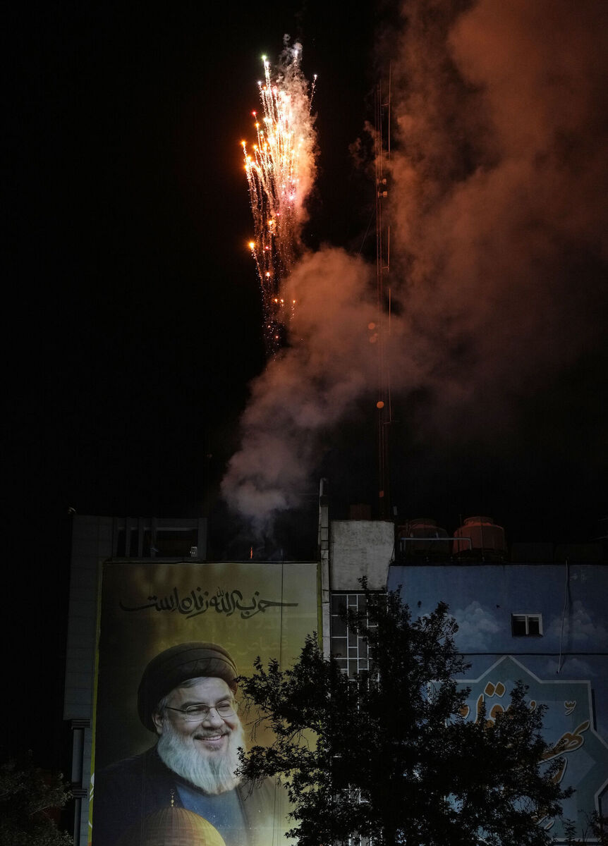 Fireworks explode over a portrait of slain Hezbollah leader Hassan Nasrallah during an anti-Israeli gathering celebrating Iran's missile strike against Israel, at Felestin (Palestine) Sq. in Tehran, Iran, Tuesday, Oct. 1, 2024. (AP Photo/Vahid Salemi)