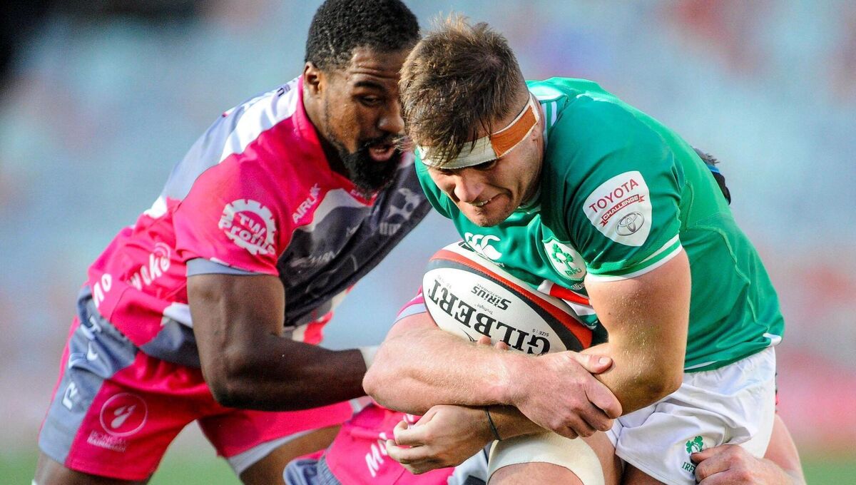 Alex Kendellen attempt to break the tackles of two Pumas players