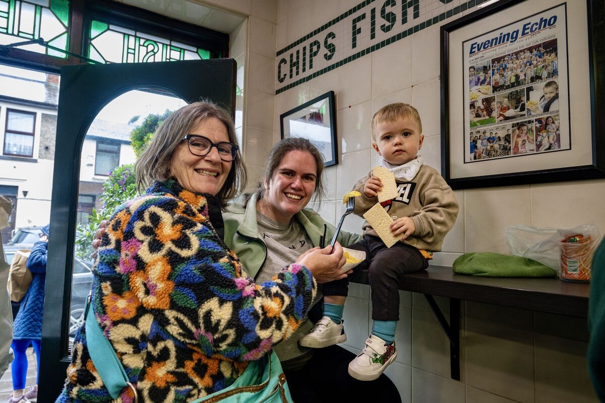 Three generations of Noonan family, Geraldine, Megan and Daniel, 3, pictured making bittersweet memories in Jackie Lennox’s chip shop where Daniel tasted his first and last Lennox chip on Friday. Picture Chani Anderson