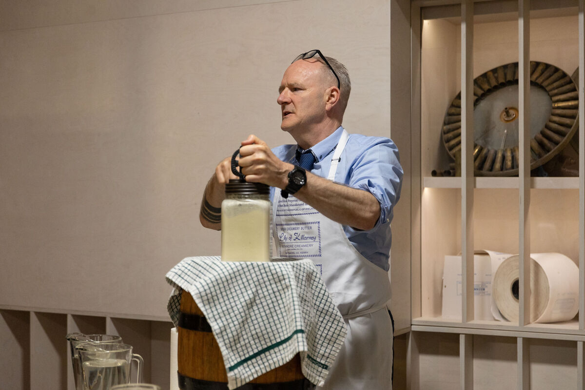 Dominic Moore demonstrating how butter was made on a tour of the Butter Museum.