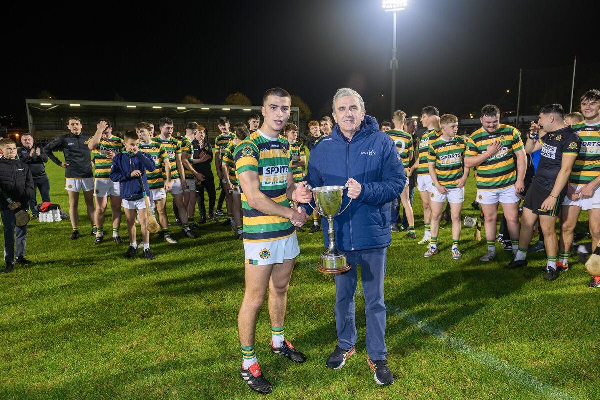  Glen Rovers captain Diarmuid Wall is presented with the trophy by Michael O'Mahony, Rebel Óg chairman, after their victory over Sarsfields in the Rebel Óg Premier 1 Minor Hurling Championship final at Páirc Uí Rinn. Pic: Dan Linehan