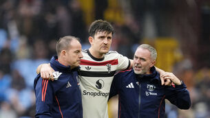 Harry Maguire, centre, is helped from the pitch (Nick Potts/PA)