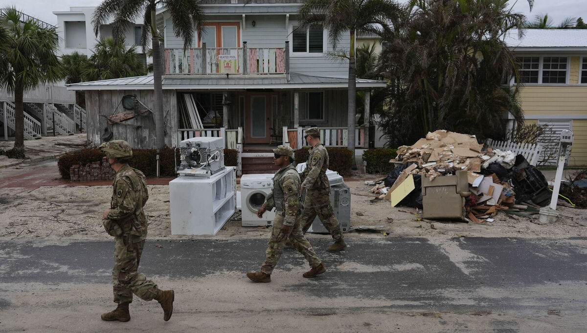 Members of the Florida Army National Guard check for any remaining residents in nearly-deserted Bradenton Beach, where piles of debris from Hurricane Helene flooding still sits outside damaged homes ahead of the arrival of Hurricane Milton. Picture: AP Photo/Rebecca Blackwell