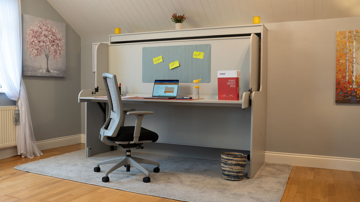 Wall beds with desks often have clever hinges allowing the desk to swing as the bed lowers, preventing items from falling off!